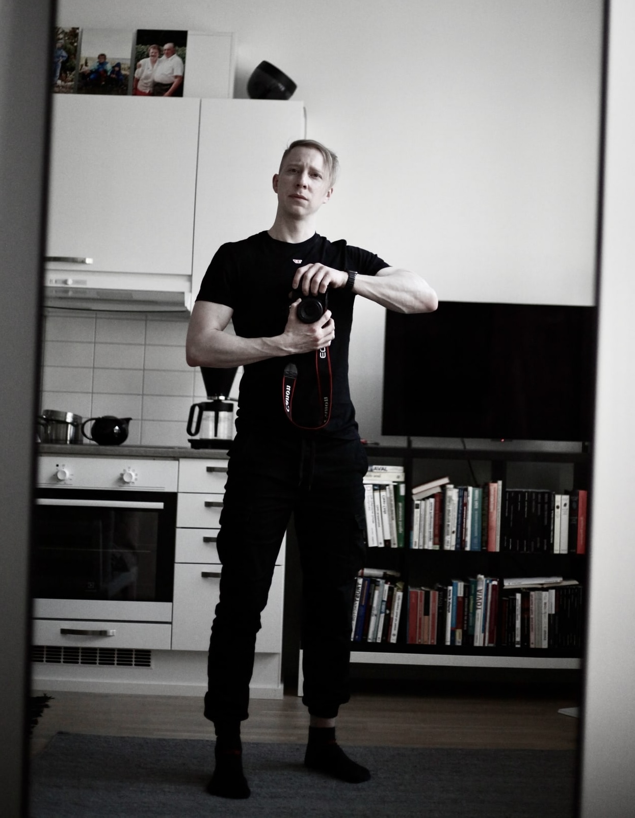 Arttu holding a camera in a mirror self-portrait.